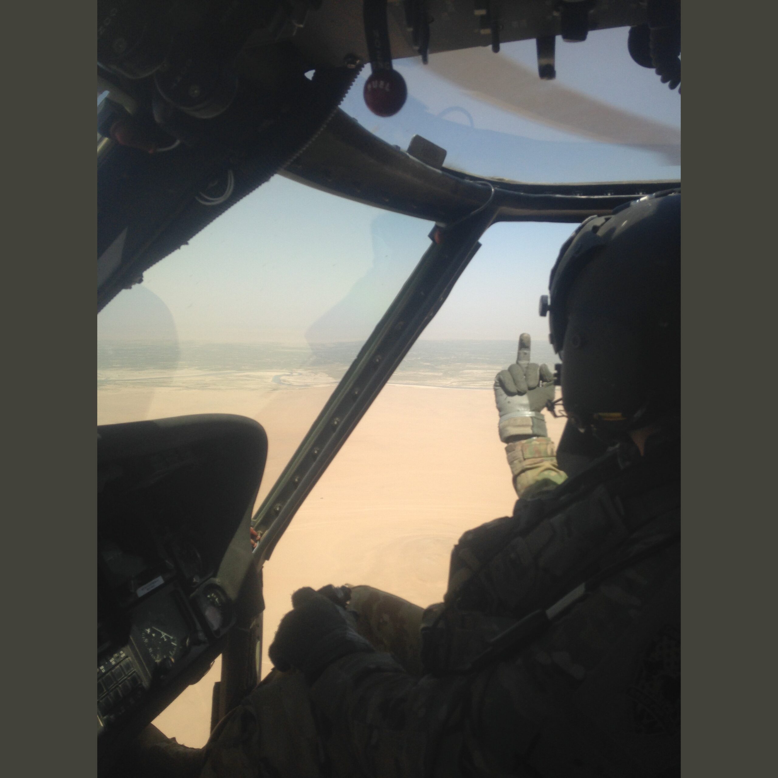 Hey, Helmand! Army helicopter pilot "CandyMan" extending his middle-finger-salute out the window of his Blackhawk at Helmund Province, Afghanistan