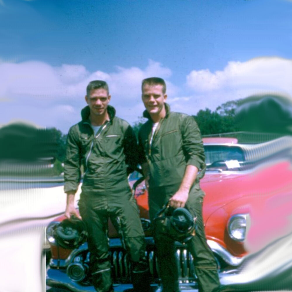 Slaf and a friend in flight suits standing in front of a red 1952 Buick convertible at NAS Pensacola