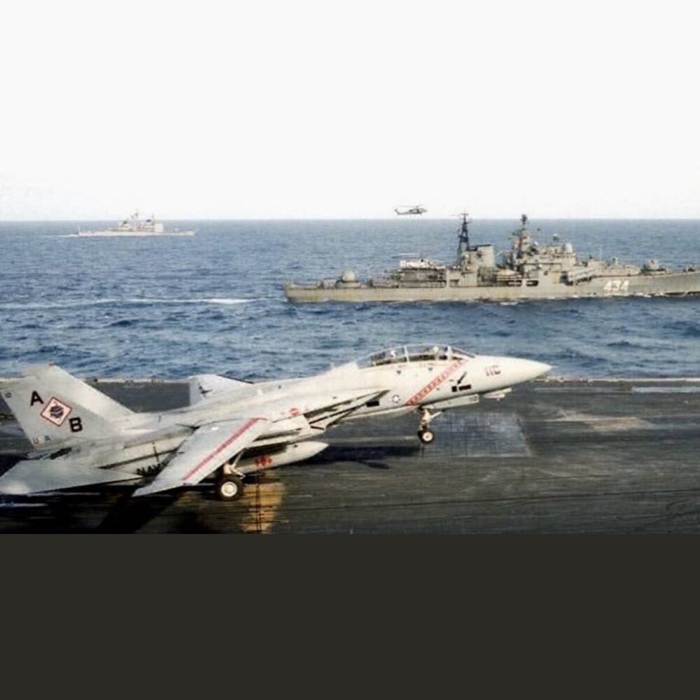 Mooch Landing on the America with Otlichnyy, a Russian Sovremenny class destroyer off the port side.