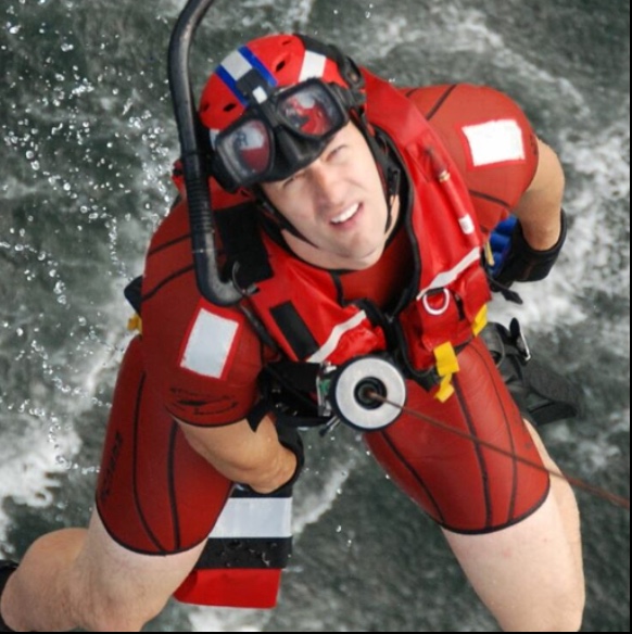 Jason Quinn USCG Rescue Swimmer on a hoist line.